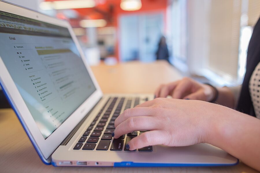 hand typing on a laptop