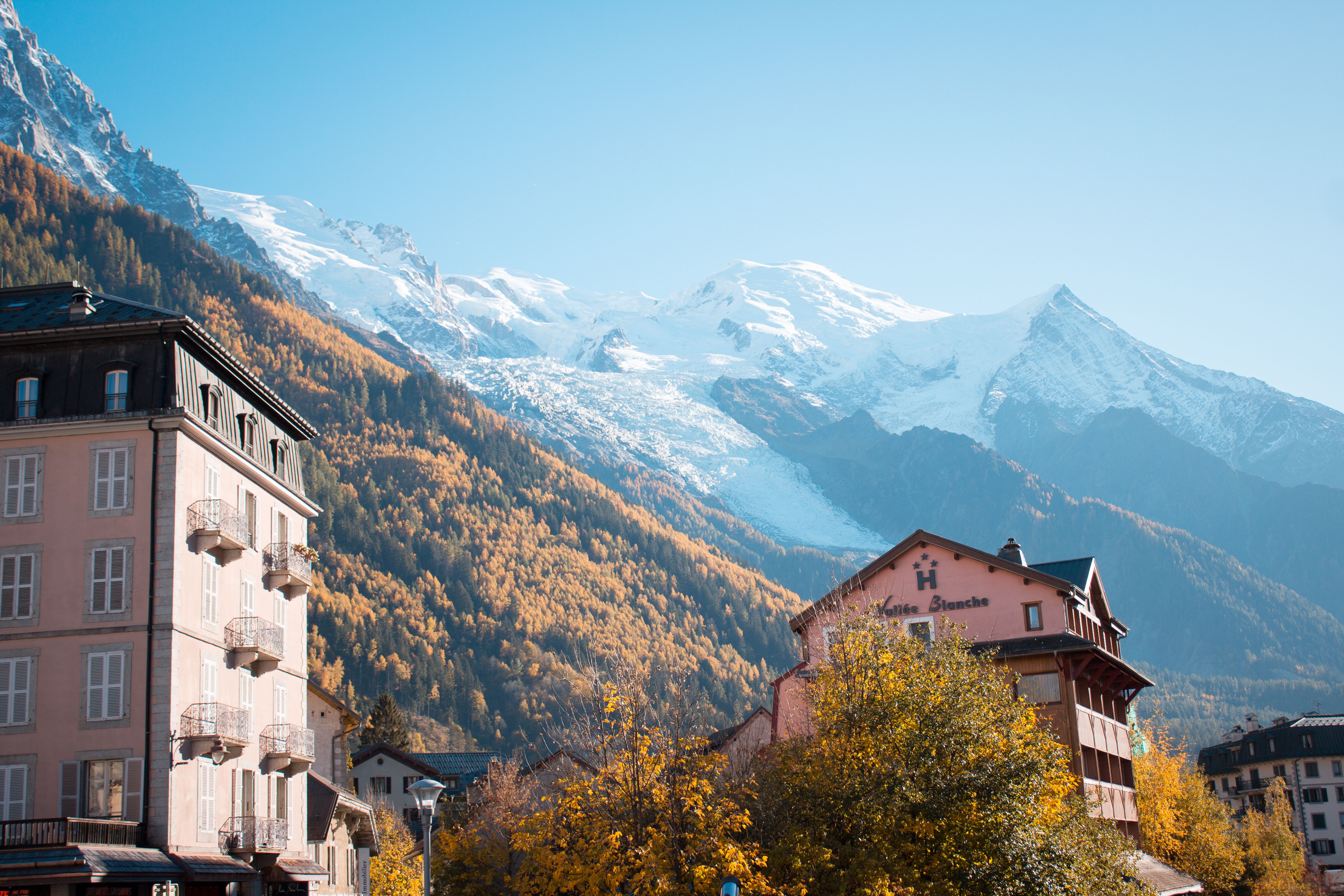 Chamonix with colorful autumn trees and snowcapped mountains in the background.