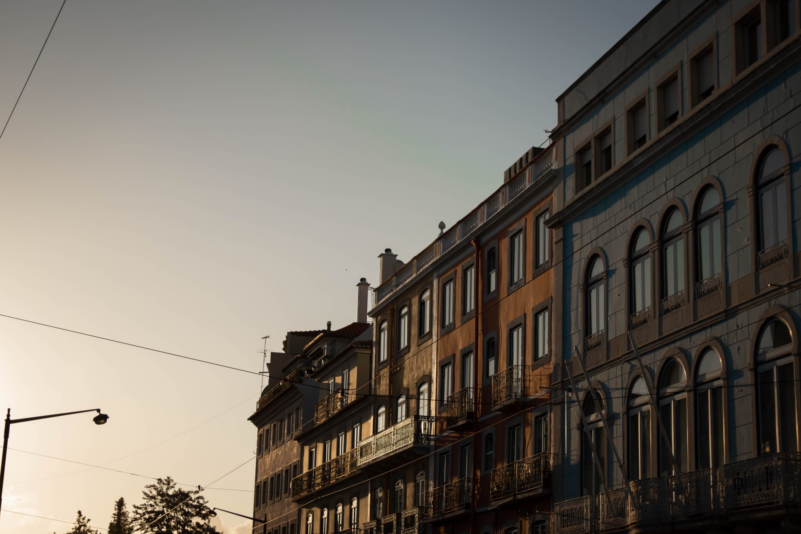 Historic Lisbon architecture glowing in warm autumn light, representing a mild-weather city escape.